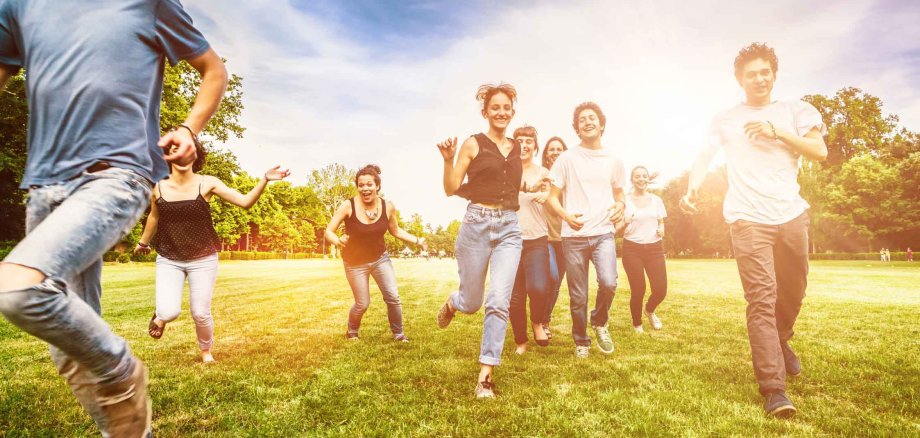 Group,Of,Friends,Having,Fun,And,Running,On,Green,Meadow